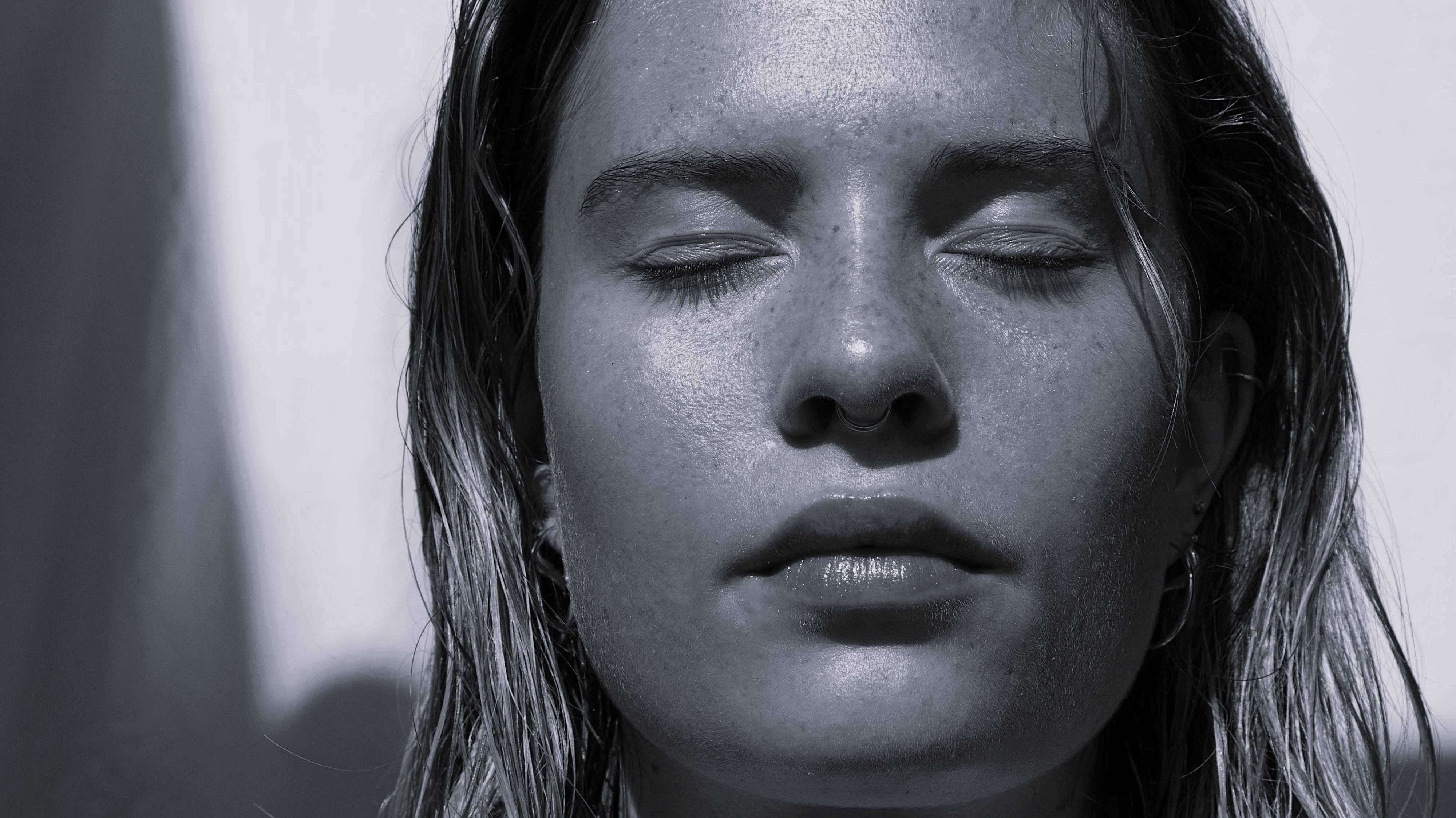 Image showing woman with eyes closed basking in the sunlight.