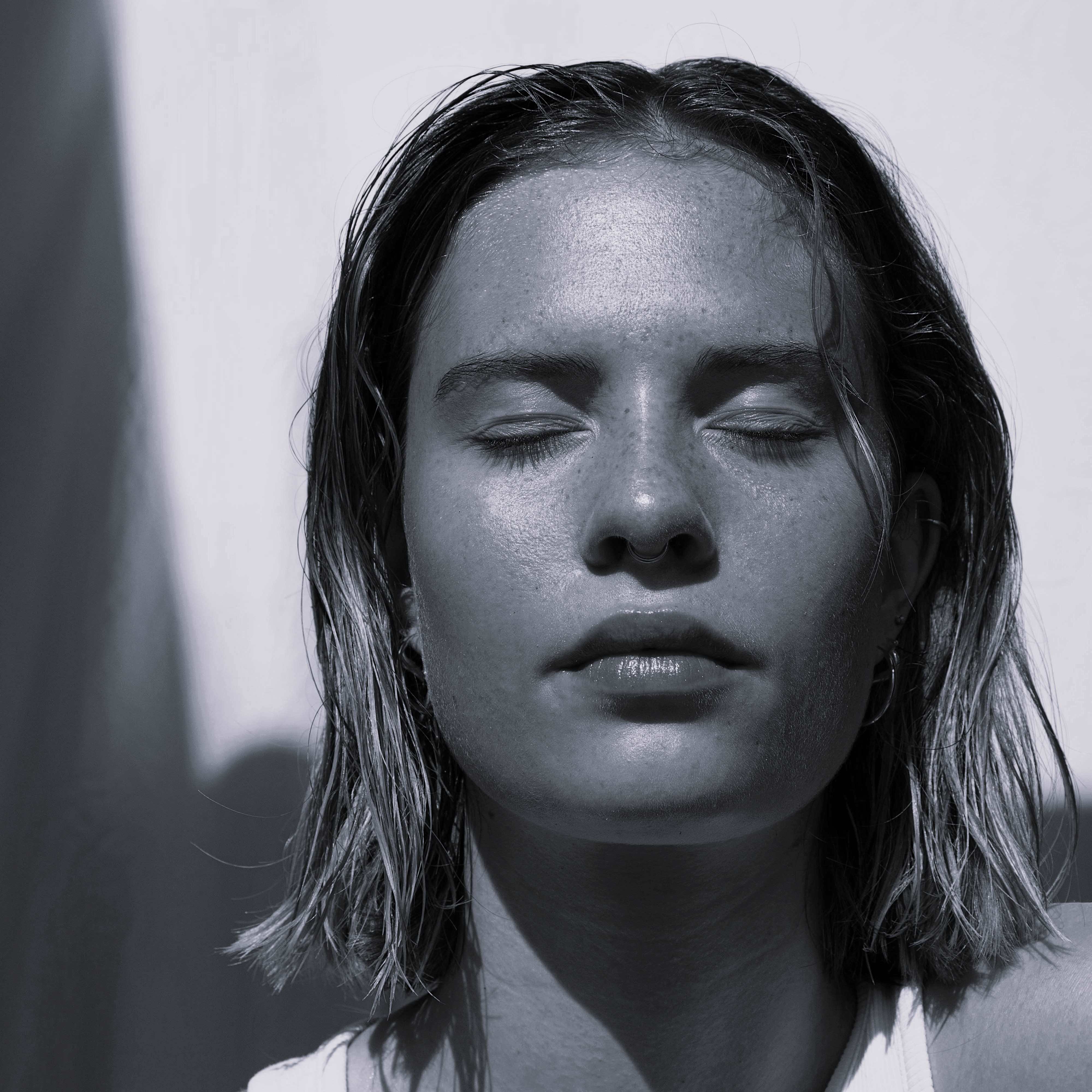 Image showing woman with eyes closed basking in the sunlight.